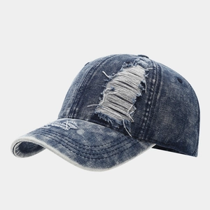 Close-up of distressed denim baseball cap with vintage frayed edges and washed finish