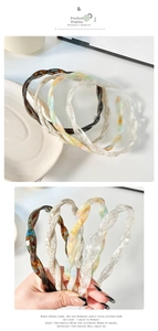 Close-up of thin twisted acetate headbands featuring elegant marble textures and colors