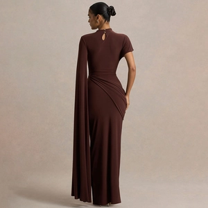 Detail of elegant back cutout and draped sleeve on a dark brown bodycon maxi dress