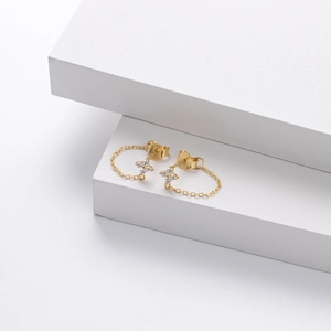 Detail shot of gold S925 sterling silver floral stud earrings with white zircon tassels