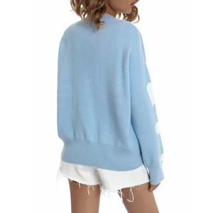 Back view of light blue knit sweater with white heart jacquard patterns on sleeves