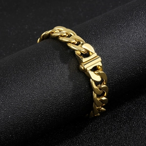 Macro detail of high-polish 13mm gold stainless steel curb chain links on black display