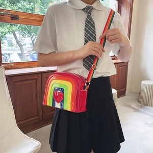 Detail of colorful rainbow crossbody bag with heart motif and wide woven strap