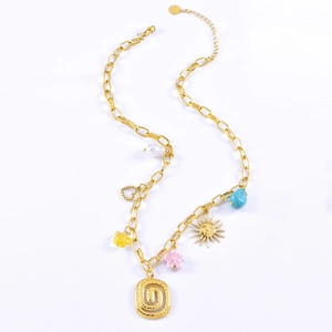 Gold chunky chain necklace with spiral oval pendant, pearl, and butterfly charms