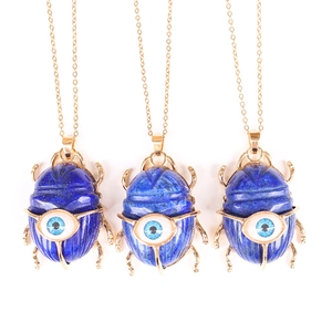 Three gold scarab necklaces with blue lapis lazuli stone and evil eye detail