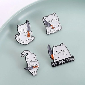 Detailed set of four cartoon cat enamel pins with humorous slogans on a tray