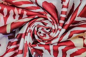 Macro view of red and white striped fabric texture with silky finish on a long dress