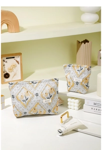 Detailed view of jacquard floral pattern and brand label on canvas makeup bags
