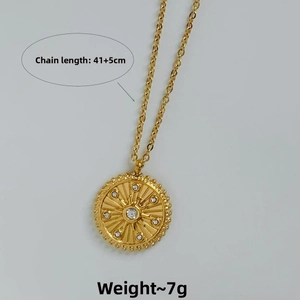 Detail of gold sunburst pendant necklace with cubic zirconia inlays and link chain