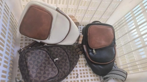 Three PU leather chest bags in white, black, and brown with patterned shoulder straps