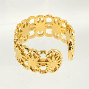 Macro shot of gold hollow flower pattern on adjustable stainless steel ring