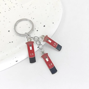 British style keychains featuring red London post office mailbox charms on a white plate