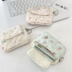 Detailed view of quilted cotton card cases featuring floral, bunny, and bear patterns
