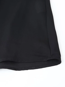 Close-up of black lace dress hemline showing high-quality stitching and fabric texture