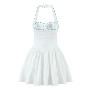 Close-up of white halter dress with blue scalloped embroidery and invisible back zipper