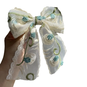 Elegant large lace embroidery bow hair clip with vintage floral vine patterns in cream