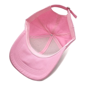 Detail view of pink baseball cap interior with six-panel stitching and metal buckle