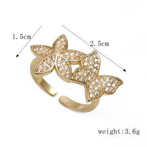 Adjustable gold flower ring with micro-pave cubic zirconia stones on white background