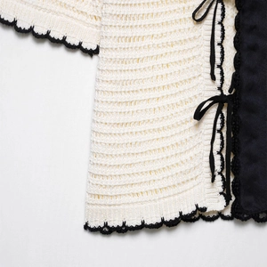 Retro cream knit polo top with black contrast trim and textured crochet detailing