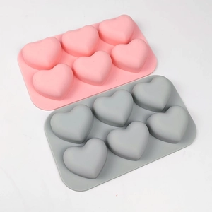 Detail view of 6-cavity heart shaped silicone molds in pink and gray for DIY baking
