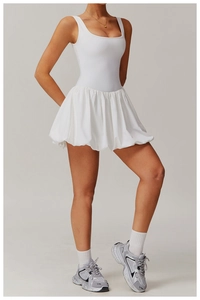 Detailed full-body shot of white sleeveless bubble hem athletic dress with retro sneakers