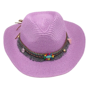 Detailed view of purple straw cowboy hat with ethnic beads and fringe decoration