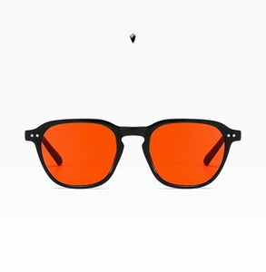 Detail view of glossy black frames with red lenses and anti-slip temple texture