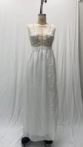 Close-up of white lace floral embroidery on the deep V-neck of a bridal evening gown