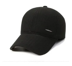 Detail view of black wool baseball cap with silver metal feather pin accessory