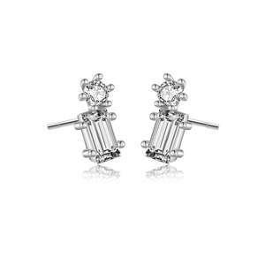 Macro shot of silver earrings featuring round and rectangular cubic zirconia settings