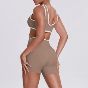Detail of coffee-colored high-waisted yoga set with contrast white trim and slim-fit cut