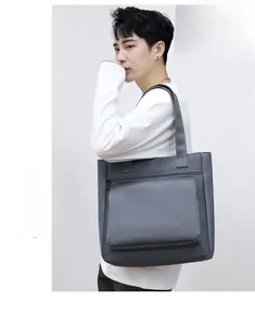 Close-up of gray waterproof nylon tote bag with front zipper pocket for men's daily commute