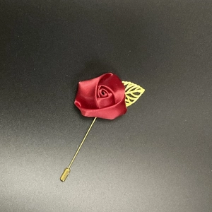 Men's suit lapel pin featuring a dark red satin rose and a golden hollow leaf detail