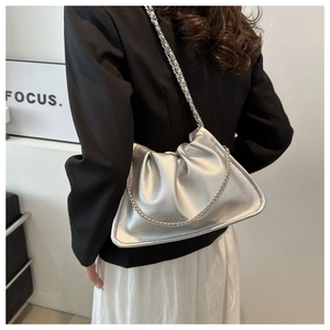 Detail of silver PU leather bucket bag featuring pleated design and metal chain strap