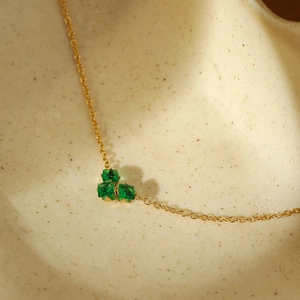 Elegant gold-tone stainless steel necklace featuring a cluster of green square-cut gems