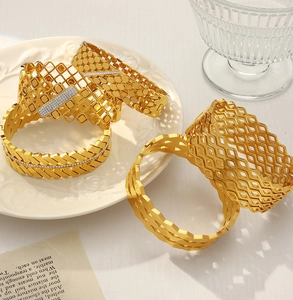 Detailed macro view of gold geometric bangle with zircon inlay on a lifestyle background