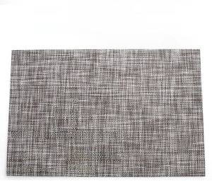Detail showing regular shape and four-sided overlocking on brown woven PVC placemat
