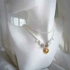 Detail of double-layer necklace with baroque pearls and floral oil painting pendant
