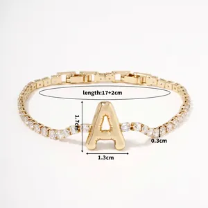 Detailed view of gold letter A pendant bracelet with cubic zirconia and chain measurements