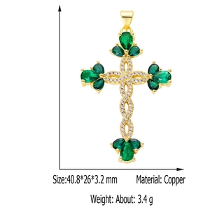 Close-up of golden copper cross pendant with green drop stone and sizing details