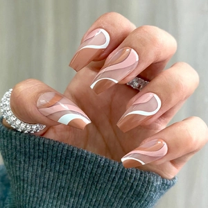 Macro detail of long coffin press-on nails with pink and brown wave patterns