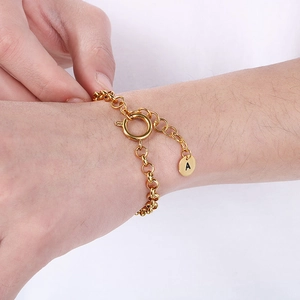 Close-up of 18k gold-plated stainless steel chain bracelet with letter A pendant