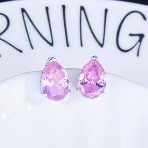 Close-up of pear-cut pink gemstone earrings set in a silver-toned metal base
