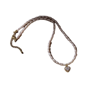 Elegant rice pearl necklace with heart-shaped crystal pendant and gold clasp