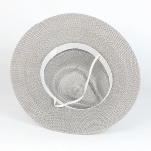 Detail of the inner mesh structure of a breathable straw sun hat with an elastic chin strap