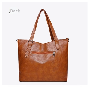 Detailed back view of brown lychee grain leather tote bag with functional zipper pocket