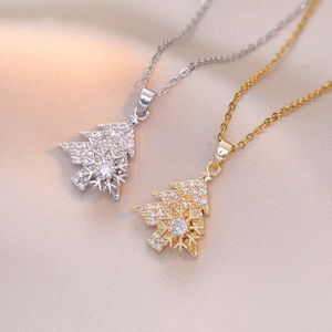 Collana albero di Natale e fiocco di neve rotante in titanio con pavé di zirconi
