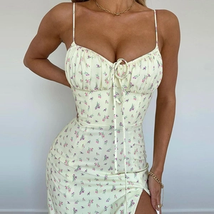 Detail of floral spaghetti strap dress showing the ruched bust and side slit on light fabric