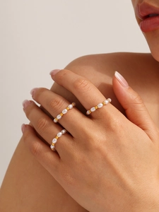 Close-up of elegant 18K gold plated beaded pearl ring set worn by a model