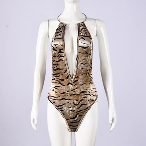 Detail of tiger print bodysuit featuring a deep V-neckline and halter neck design